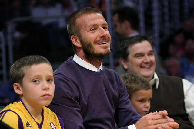 <p>Brooklyn Beckham (pictured left aged 9, with father David and brother Romeo) complained that ‘inauthentic relationships have been a fixture of the life I was born into’</p>