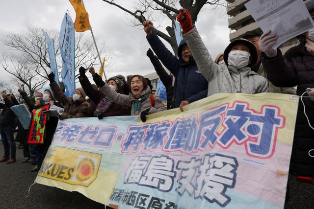 <p>Protesters take part in a rally near Niigata prefectural government office building before voting takes place in the prefectural assembly </p>