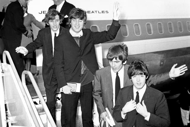 <p>Ringo Starr, John Lennon, George Harrison, and Paul McCartney board a plane at Heathrow Airport for their tour of America (PA)</p>